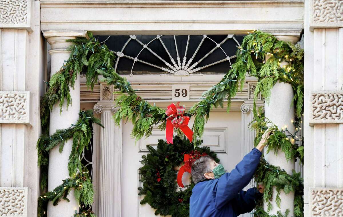 Karen Peterson joins fellow Van Rensselaer Gardening Club members who volunteered their time to decorate Hart Cluett Museum ahead of Troy's Victorian Stroll on Thursday, Dec. 3, 2020, on Second Street in Troy, N.Y. (Will Waldron/Times Union)