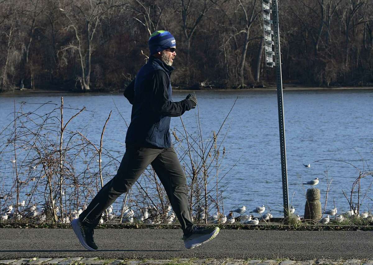 A jogger is seen making his way along the Mohawk Hudson Bike Trail near the Corning Preserve boat launch on Thursday, Dec. 3, 2020 in Albany, N.Y. (Lori Van Buren/Times Union)