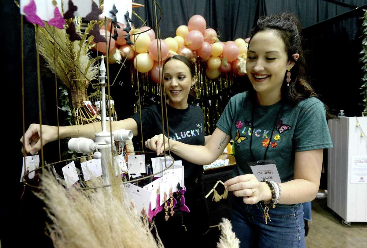 Lucky Pepper Co.'s Peyton Provost (right) and Kelci Crawford talk as they and other vendors set up their booths for the Friday morning opening of the Junior League of Beaumont's annual Main Street Market at the Civic Center. Doors open at 10 a.m., and admission is free Friday night from 5 - 8 p.m. Photo taken Thursday, December 3, 2020 Kim Brent/The Enterprise