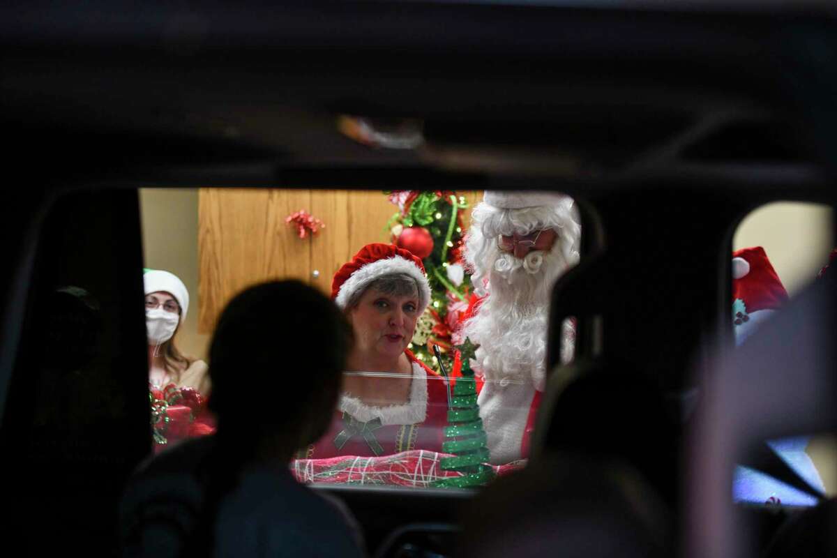 Mr. and Mrs. Claus talk to students during FirstCapital Bank of Texas’ drive-thru Christmas events for students at Bonham Elementary School on Thursday, Dec. 3, 2020 at 5606 West Wadley Avenue. Jacy Lewis/Reporter-Telegram