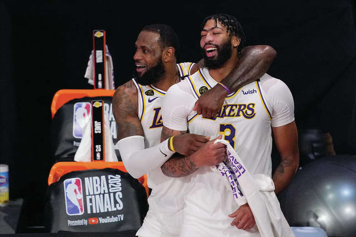 Los Angeles Lakers’ LeBron James, rear, and Anthony Davis (3) celebrate after the Lakers defeated the Miami Heat 106-93 in Game 6 of basketball’s NBA Finals in Lake Buena Vista, Fla., in this Oct. 11, 2020, file photo. Anthony Davis is finalizing a five-year contract worth up to $190 million to return to the Los Angeles Lakers.