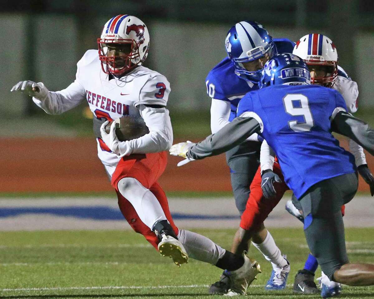 Albert Slaughter sidesteps tackler to pick up yards for the Mustangs as Jefferson plays Memorial at Edgewood Memorial Stadium on Dec. 3, 2020.