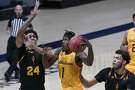 California guard Joel Brown (1) goes to the basket between Arizona State's Jalen Graham (24) and Taeshon Cherry during the second half of an NCAA college basketball game in Berkeley, Calif., Thursday, Dec. 3, 2020. (AP Photo/Jeff Chiu)