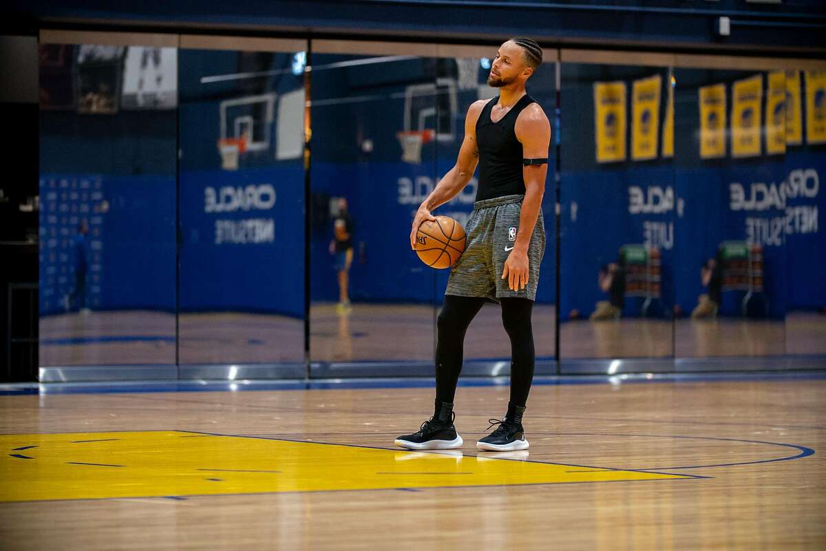 Warriors guard Stephen Curry practices on the first day of training camp at Chase Center on Wednesday. The team is scheduled to begin full-team workouts Monday.