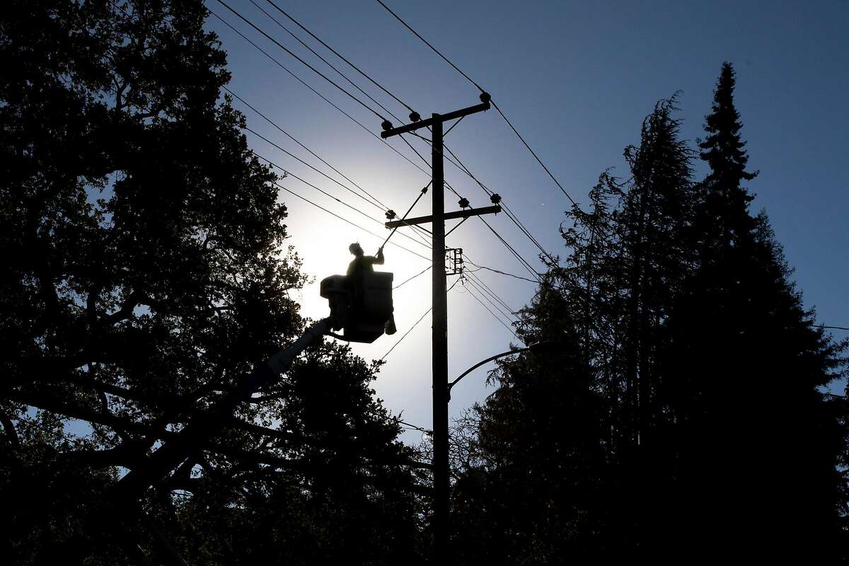 PG&E line inspector Kevin Ogans works to clear lines in October 2020. The company is intentionally shutting off power for the first time in January due to wildfire risks.