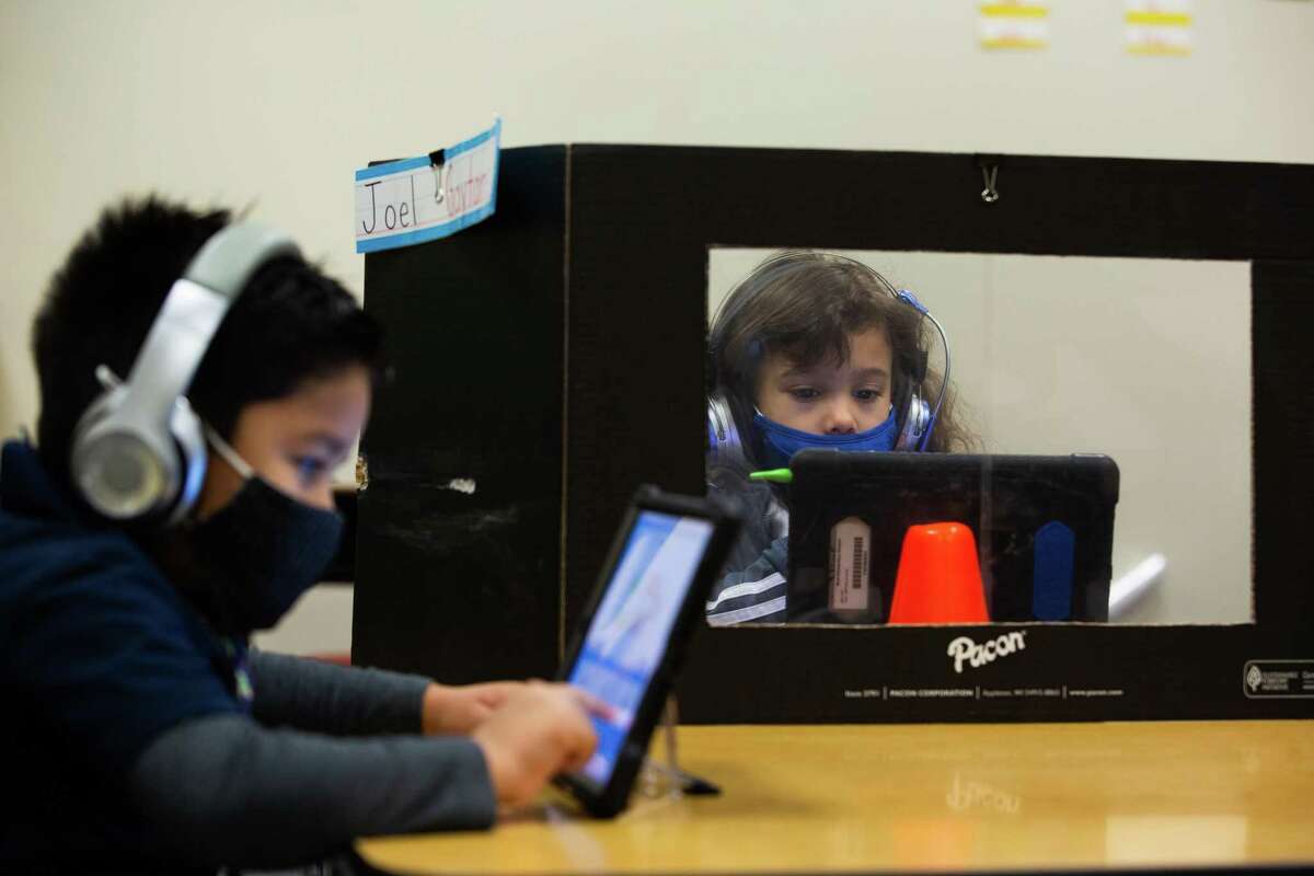 Best Elementary School kindergarten students Joel Gaytan and Kamila Flores use a tablet during a math class, Thursday, Dec. 3, 2020, in Houston.