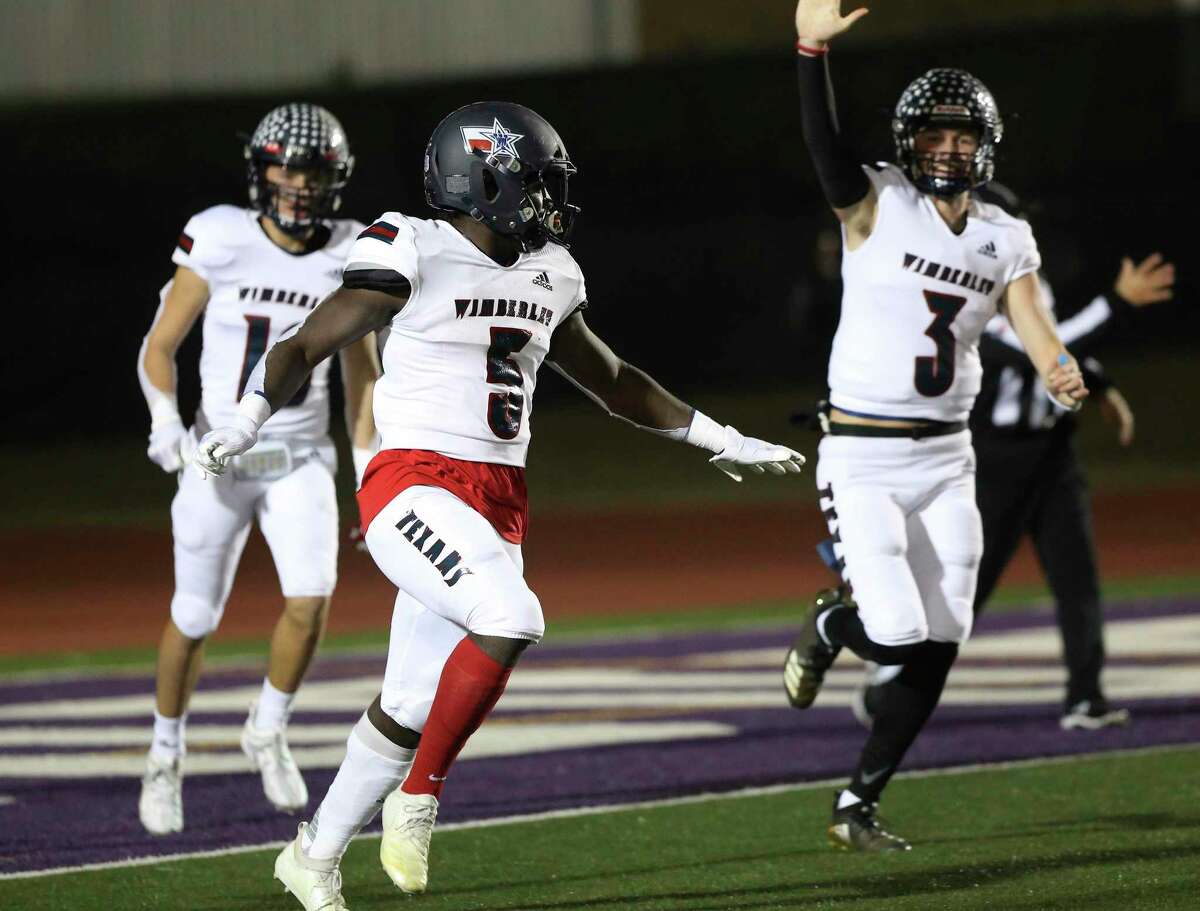 Wimberley Texans' Moses Wray (05) celebrates with teammates including quarterback Matthew Tippie (03) after his 66-yard touchdown run against Navarro Panthers during their Class 4A Division II state quarterfinal football game in Boerne on Friday, Dec. 4, 2020.
