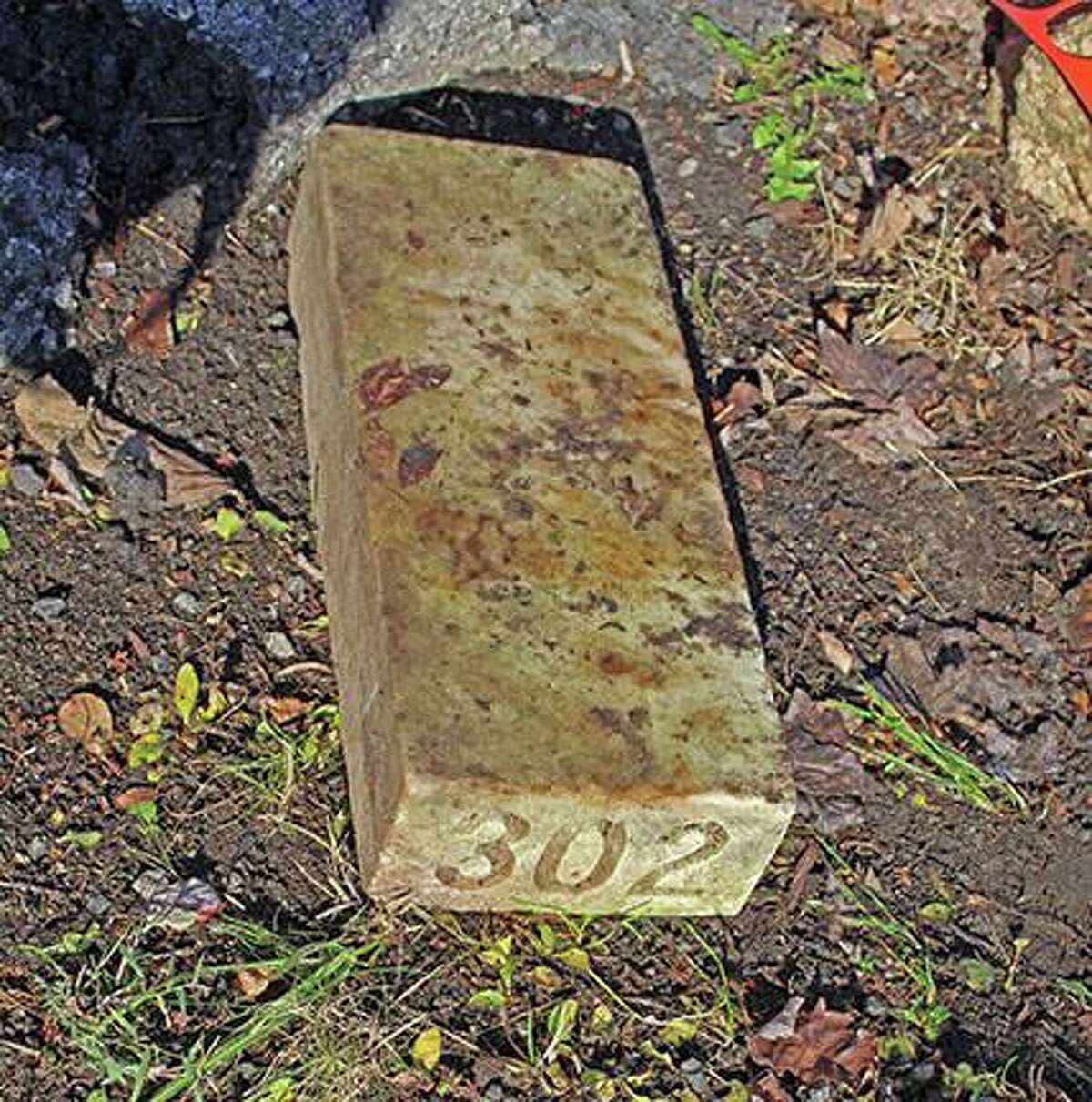 John Breunig ‘Potter’s Field’ grave markers discovered lining lawn at