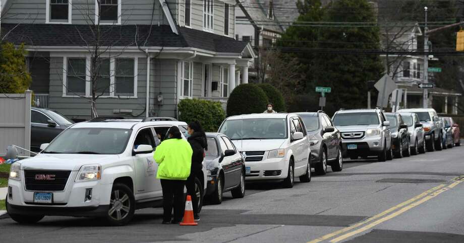 A line of cars stretches down the block as patients wait in their cars to be tested for COVID-19 at Community Health Center in Stamford, Conn. Wednesday, Dec. 2, 2020. Community Health Center's COVID-19 testing line has stretched around the block with patients often waiting several hours. Photo: Tyler Sizemore / Hearst Connecticut Media / Greenwich Time