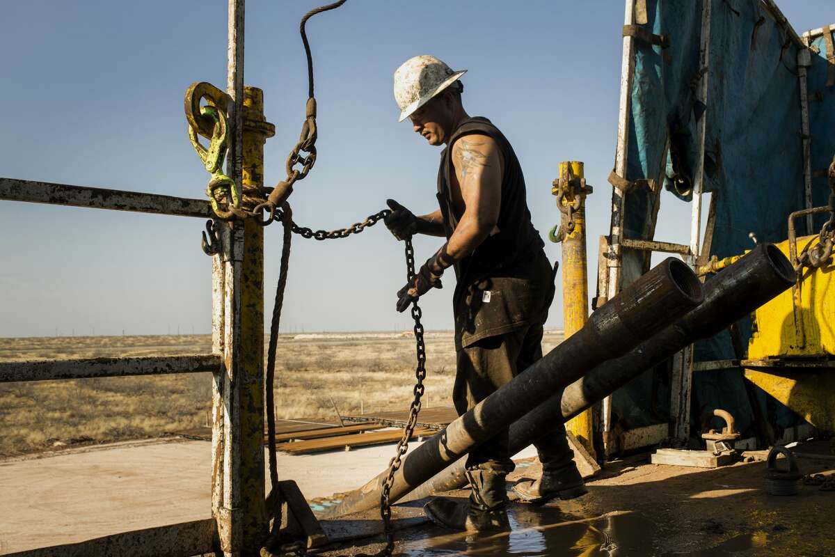 A worker prepares to lift drills by pulley to the main floor of Endeavor Energy Resources LP's Big Dog Drilling Rig 22 in the Permian basin outside of Midland in this  file photo. 