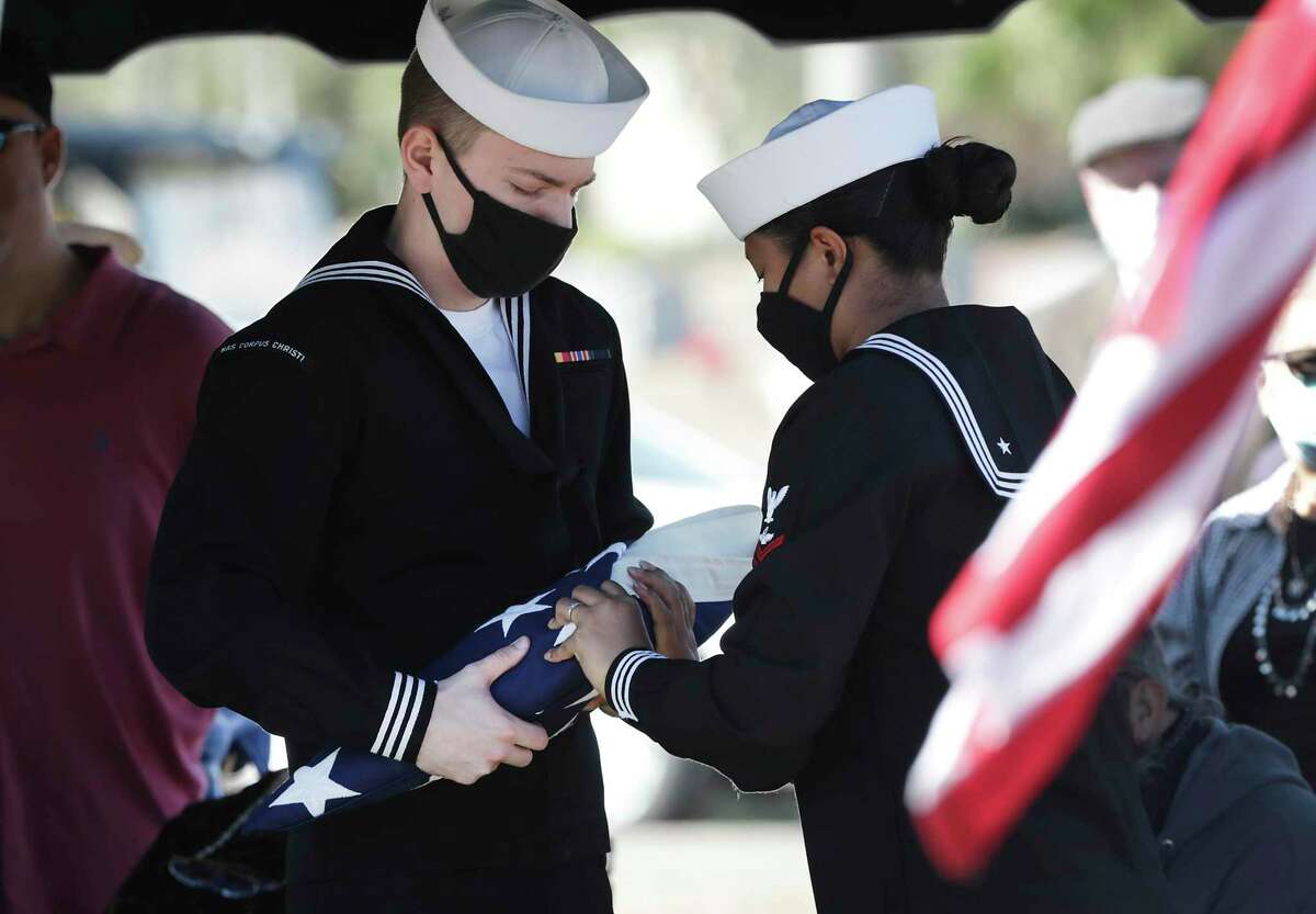 Seaman 1st Class Abner James "A.J." Dunn of Floresville, a Pearl Harbor survivor, was buried at Seaside Memorial Park in Corpus Christi on Tuesday. Members of a U.S. Navy honor guard prepare his flag to present to his wife, Grace Dunn.