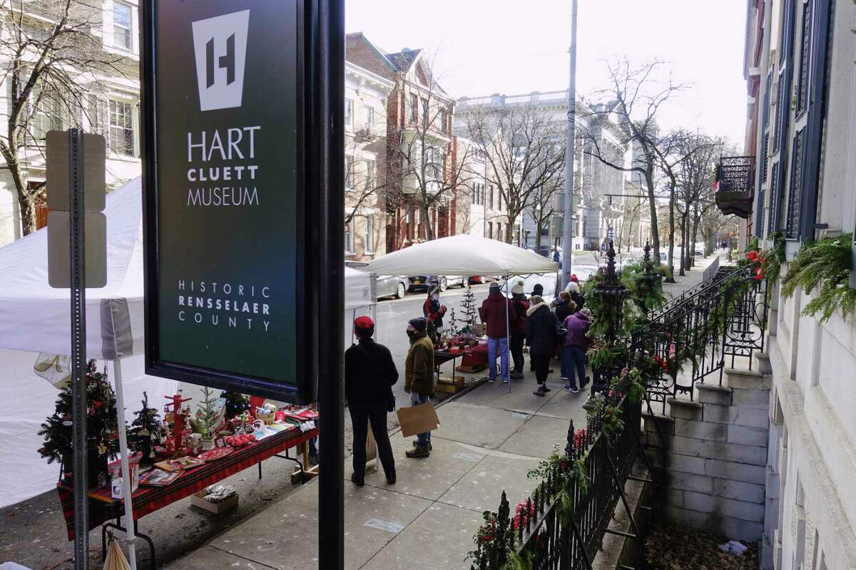People shop at the holiday market outside the Hart Cluett Museum during the first day of the Troy Victorian Stroll events on Sunday, Dec. 6, 2020, in Troy, N.Y. This year due to the pandemic, the Troy Victorian Stroll has been changed from a one-day event to a weeks-long Victorian stroll celebration. (Paul Buckowski/Times Union)