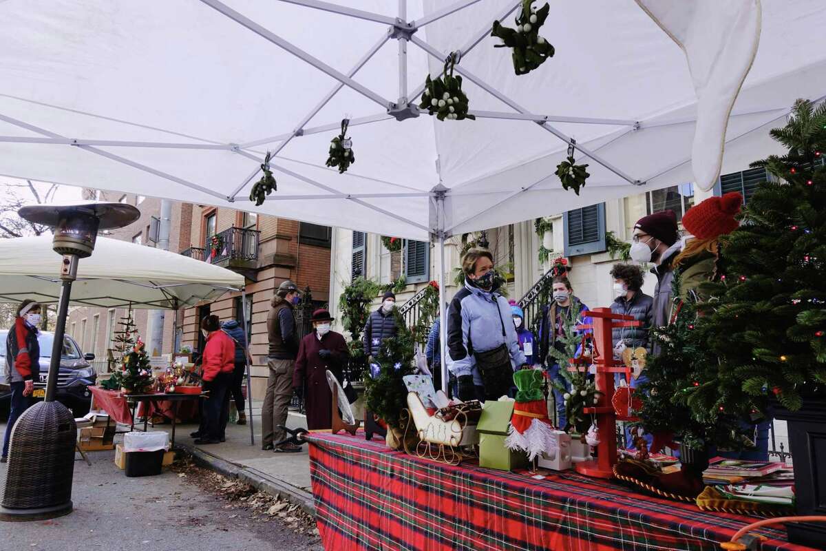 People shop at the holiday market outside the Hart Cluett Museum during the first day of the Troy Victorian Stroll events on Sunday, Dec. 6, 2020, in Troy, N.Y. The Victorian Stroll will celebrate its 40th anniversary on Dec. 4, 2022. (Paul Buckowski/Times Union)