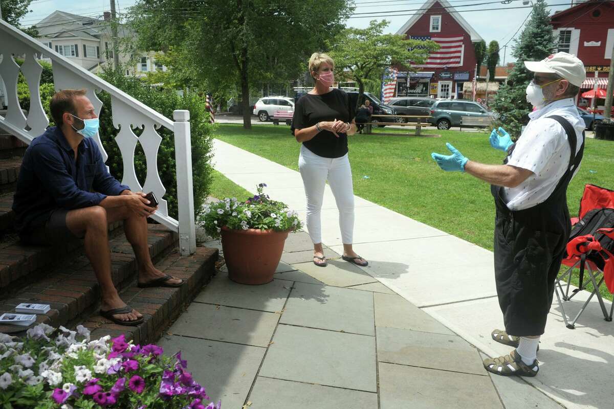 Ira Robbin, right, speaks with State Rep. Brian Farnen, left, and State Rep. Laura Devlin, center, during a brown bag lunch meeting at Sherman Green, in Fairfield, Conn. July 15, 2020.