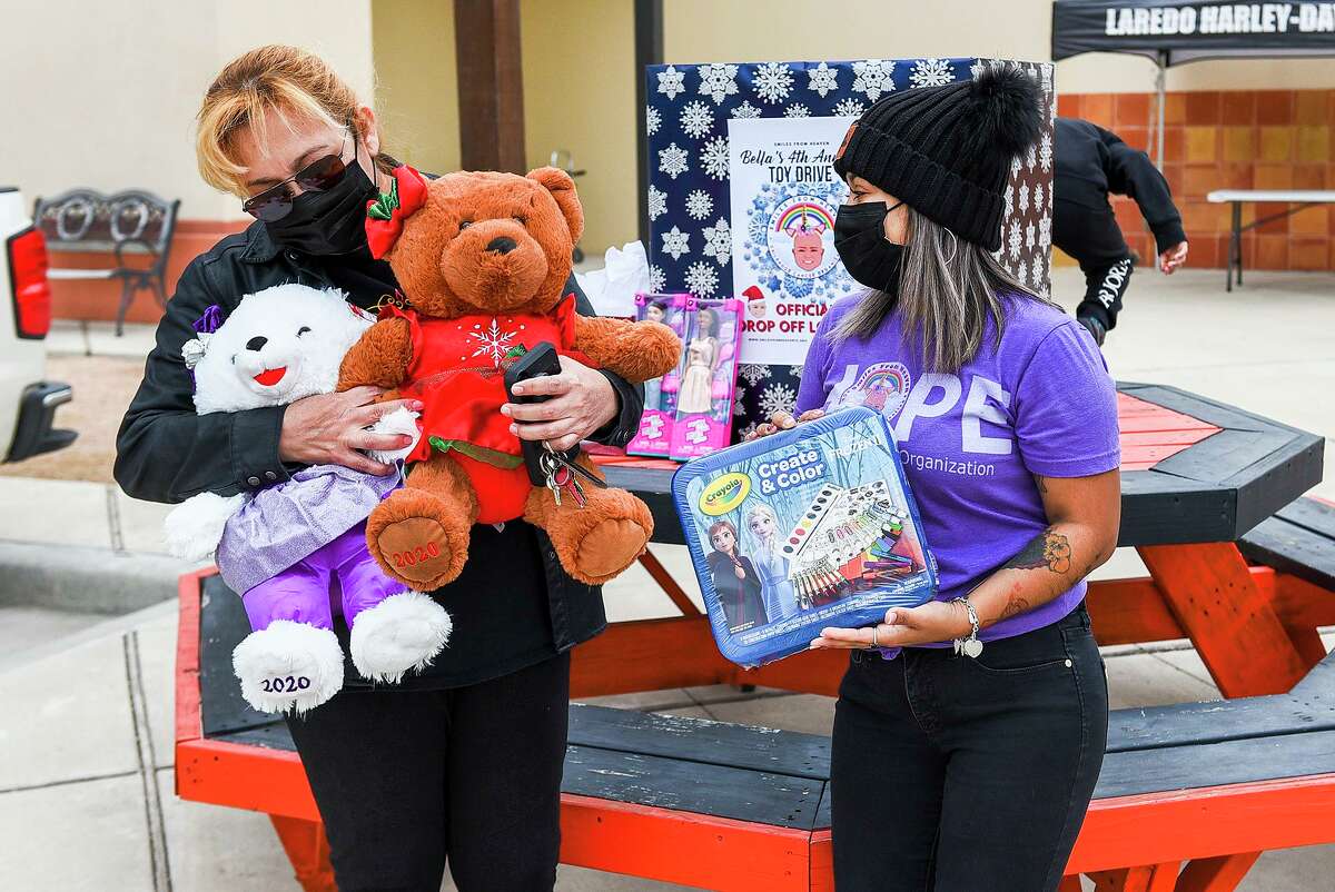 Elsa Zarate and Smiles From Heaven Vice President Betsy Sanchez gather for a photo as Zarate drops off a donation for Bella's 4th Annual Toy Drive, Saturday, outside of Harley Davidson of Laredo.