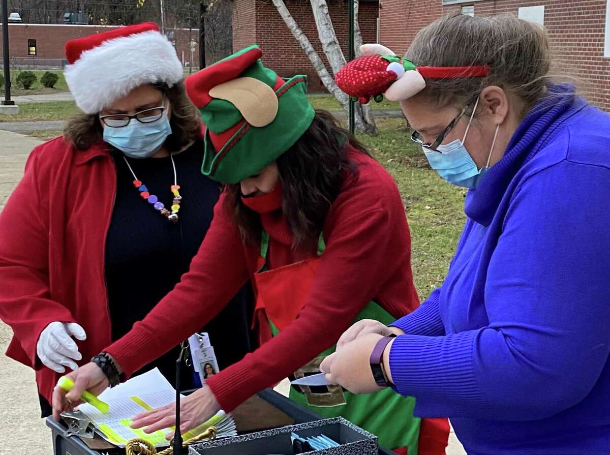 From left to right, Social Services Director Ivana Butera, volunteer Wanda Fyler and fund coordinator Megan Byrd, review the final list of participating families in the Santa Fund gift distribution on Dec. 4, 2020.