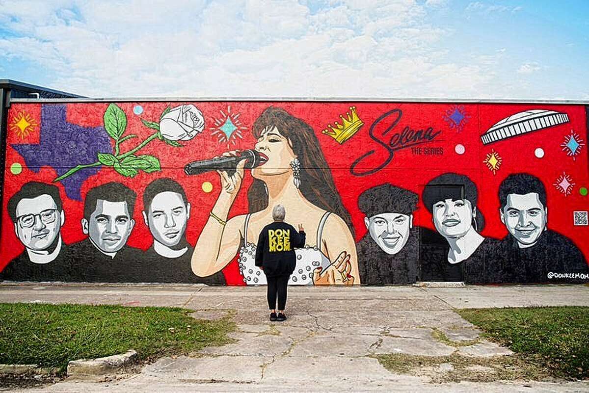 Donkeemom poses in front of her new mural paying tribute to Selena: The Series.