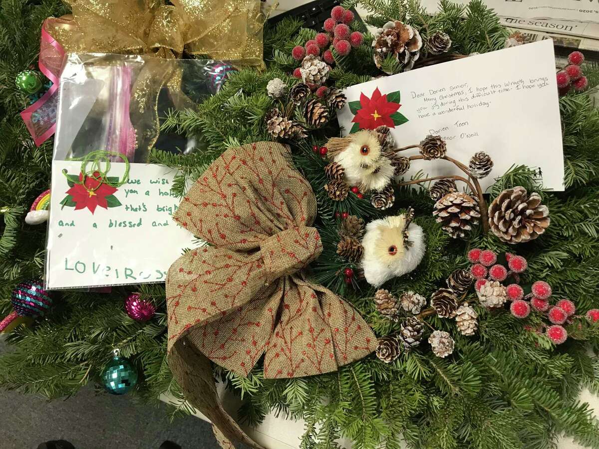 The Darien Youth Commission has been all about giving back this holiday season, creating wreaths as a surprise for seniors during their lunch pick up and running a drive-through food donation in the pouring rain Saturday.