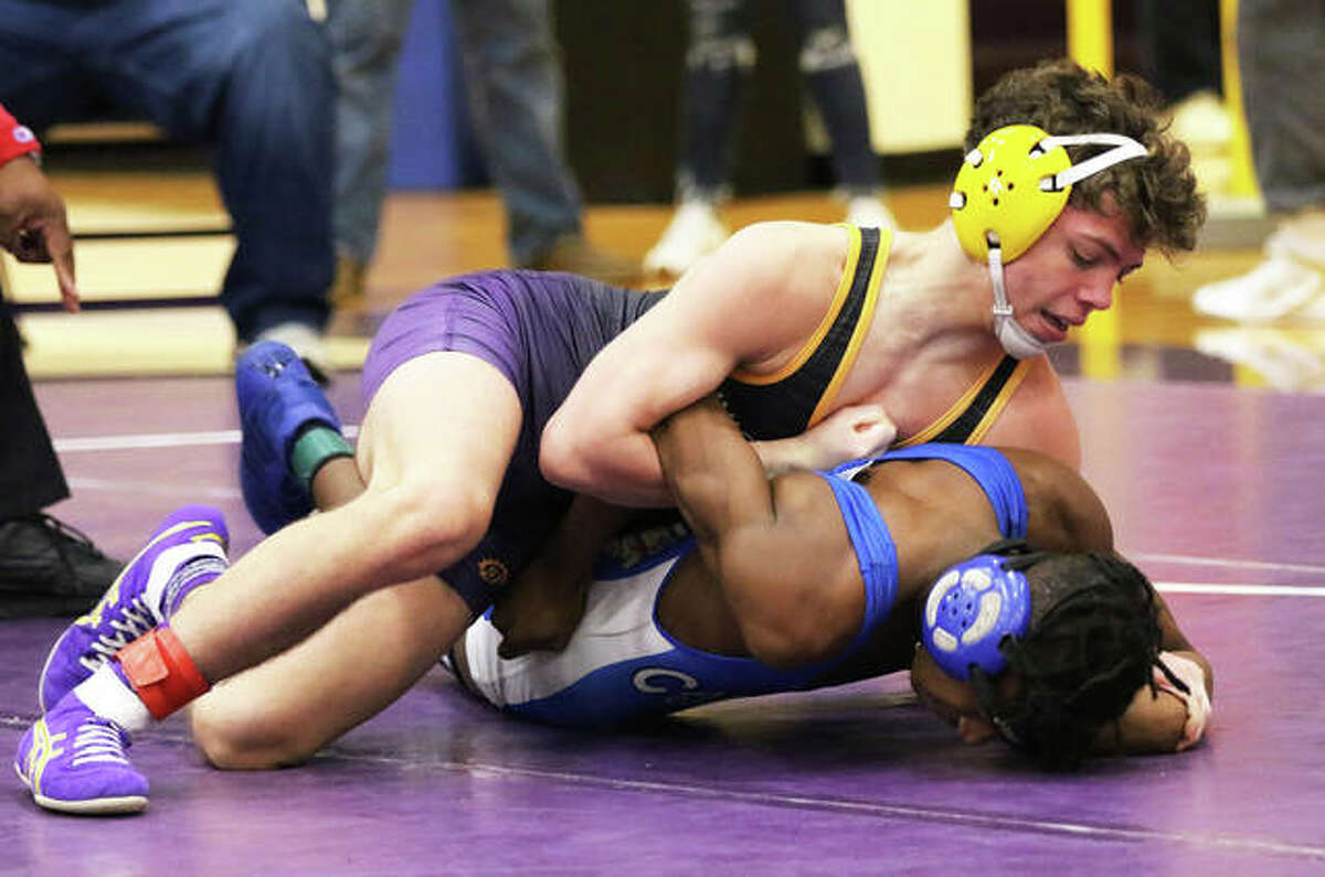 CM’s Caleb Tyus (top) works over an opponent from Cahokia during a 132-pound match at the Mascoutah Class 2A Regional last February. Tyus, who went on to place second at the Class 2A state meet, signed Monday to continue his wrestling career in college at SIUE.