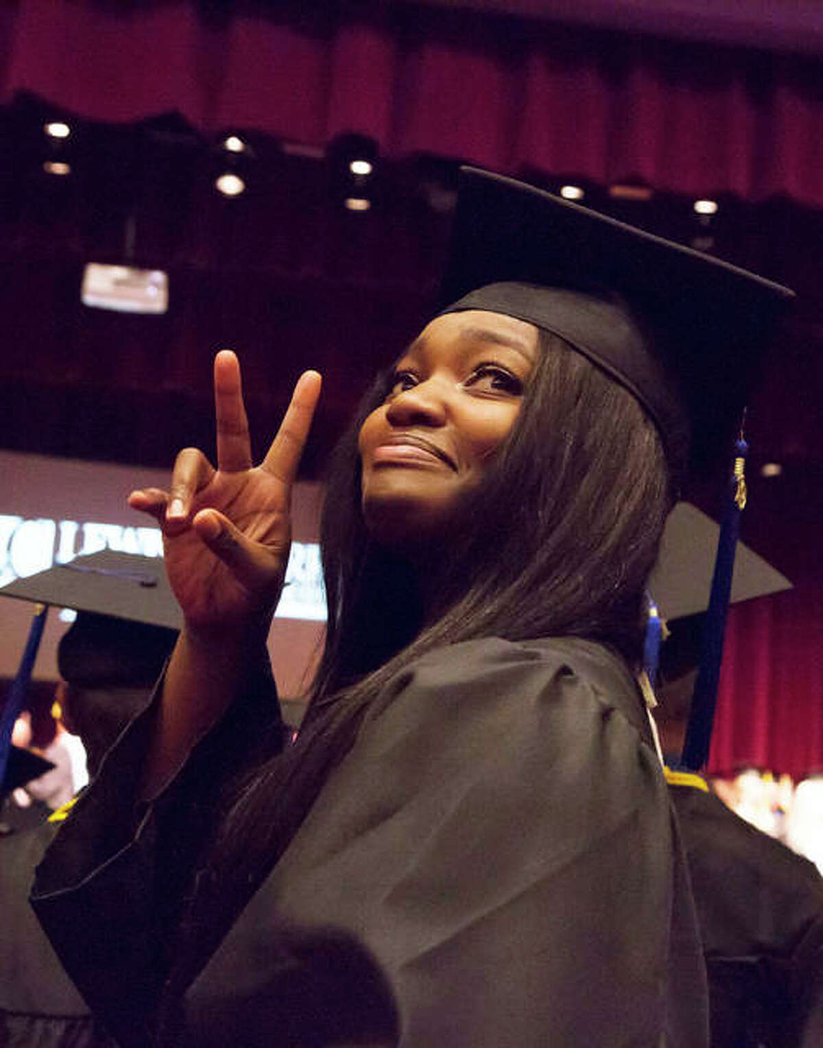 A 2019 graduate of Lewis and Clark Community College acknowledges her guests in the Hatheway Cultural Center’s Ann Whitney Olin Theatre during the 48th annual commencement, May 15, 2019.