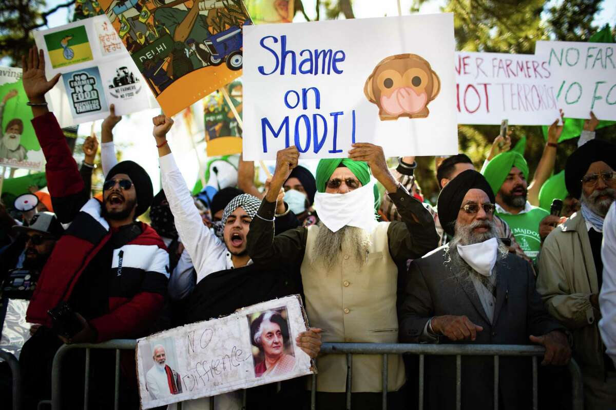 People protest rules they say hurt Punjab farmers Monday in front of the Consulate General of India in Houston.