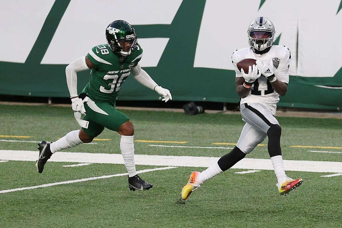 Henry Ruggs III #11 of the Las Vegas Raiders catches a touchdown pass to win the game as Lamar Jackson #38 of the New York Jets gives chase during the second half at MetLife Stadium on December 6, 2020 in East Rutherford, New Jersey. (Photo by Al Bello/Getty Images/TNS)
