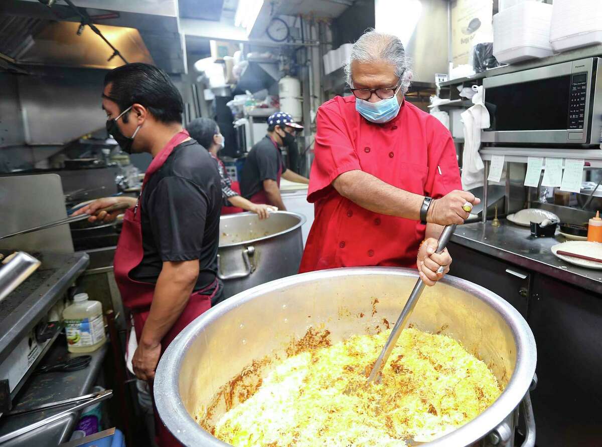Himalaya chef and owner Kaiser Lashkari stirs up a dish in the kitchen at his Houston restaurant.