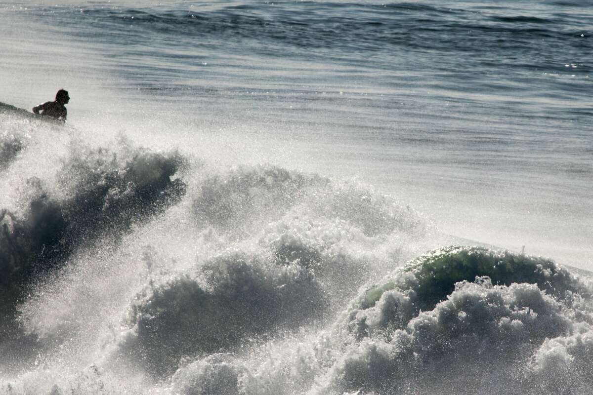 A boogie boarder rides the high waves at Ocean Beach in San Francisco on Dec. 4, 2020.