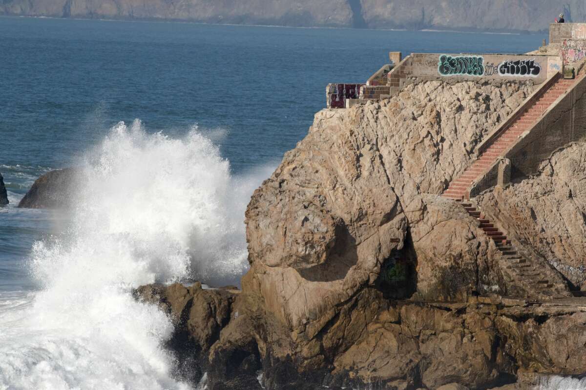 A high wave crashes against the rocks near the Sutro Baths in San Francisco on Dec. 4, 2020.