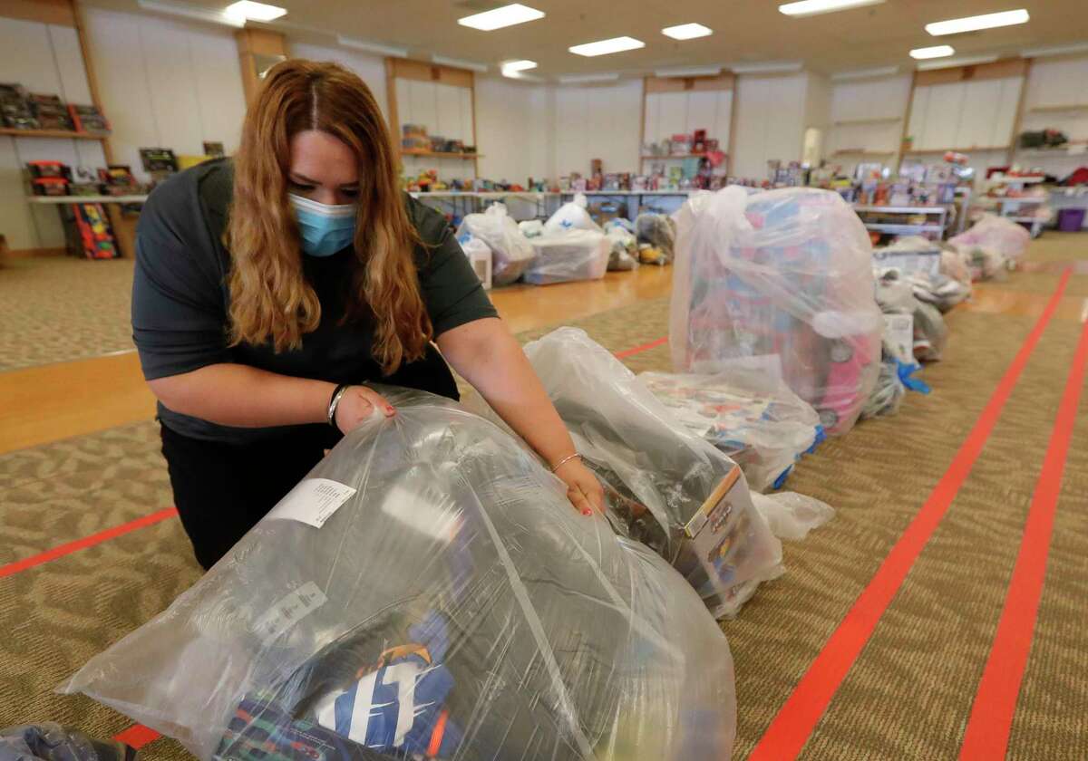 Dolores Tull helps sort through bags of toys for Salvation Army's annual angel tree gift assistance program at the Conroe Outlet Mall, Thursday, Dec. 3, 2020, in Conroe. This year's program will serve 900 families. 