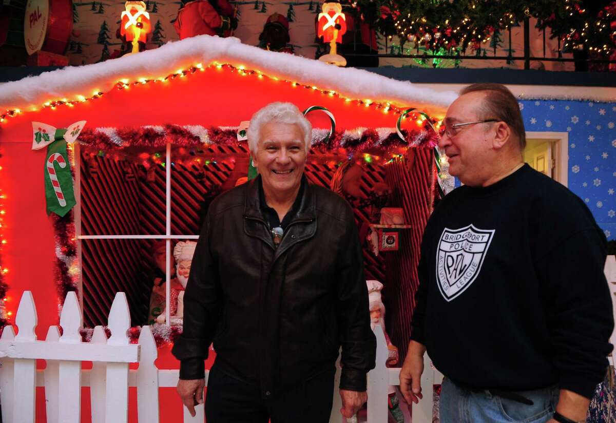 Former Bridgeport Mayor Leonard Paoletta and Mike Marella reminisce at the Christmas Village, run by the Bridgeport Police Athletic League (PAL), Thursday, Nov. 29, 2012 in Trumbull, Conn. Paoletta was in office in 1982 when the former site of the Christmas Village building burned down. He was instrumental in rallying community efforts to rebuild the village, which only took a couple of days. The village, now located on Quarry Road in Trumbull, Conn., is opening for the season on Saturday.