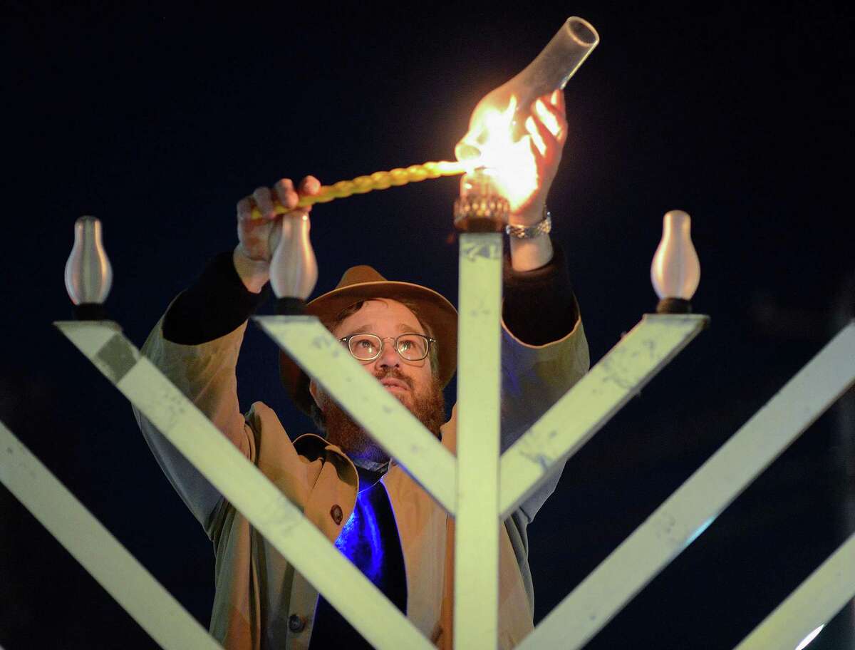 Rabbi Levi Stone of the Schneerson Center of Jewish Life lights the menorah at the Wilton town green on Dec. 22, 2019. This year the menorah will be lit Sunday, Dec. 13.