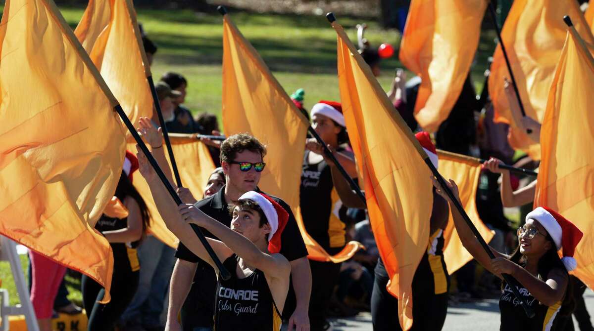 Members of the Conroe High School Tiger Band’s flag line perform during the annual Christmas parade through downtown Conroe, Saturday, Dec. 14, 2019. The parade is Saturday at 1 p.m. in downtown Conroe.