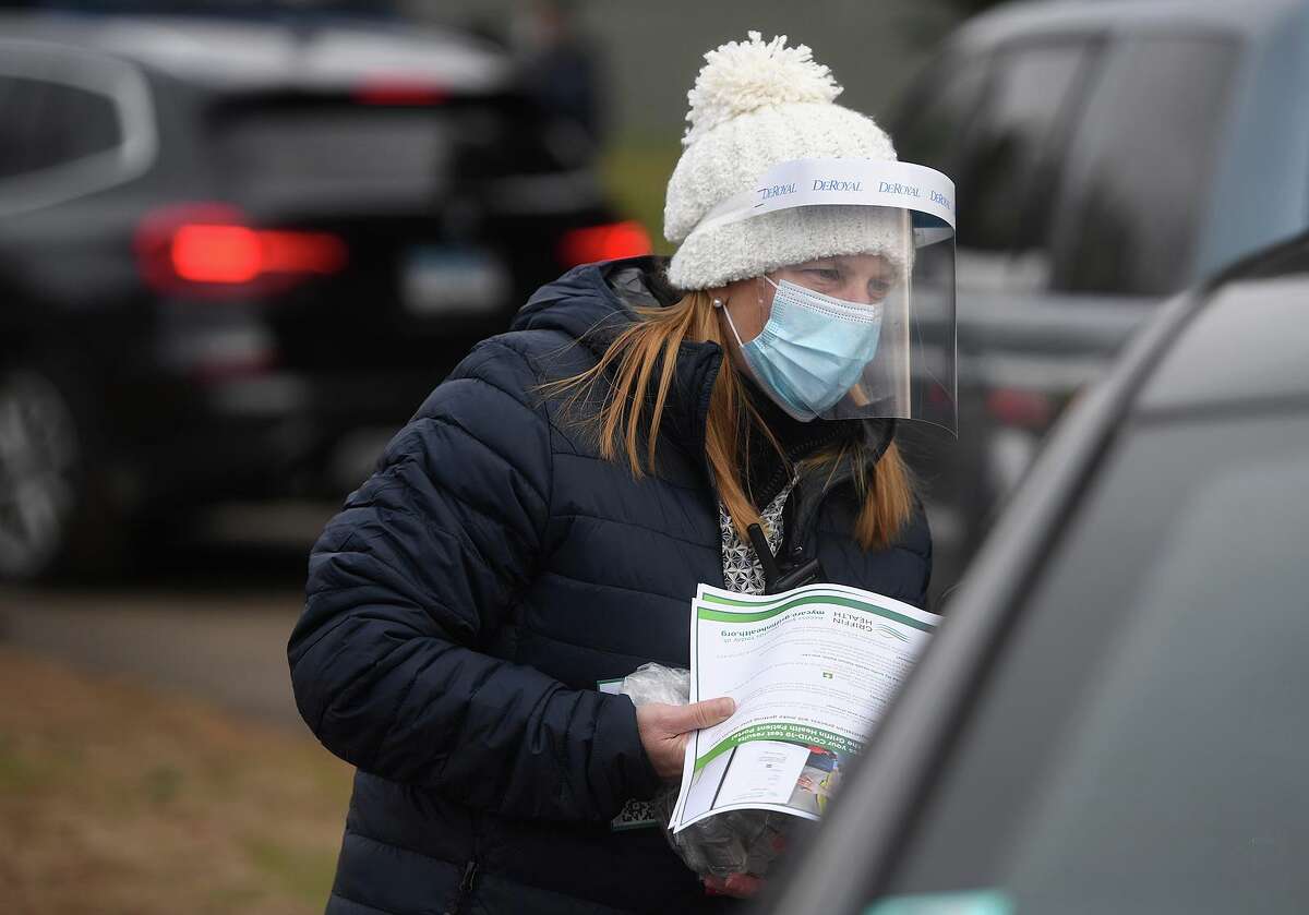 Shayne Seccombe, of Seymour, checks in visitors to Griffin Hospital's new drive through Covid-19 testing site at Unity Park in Trumbull, Conn. on Tuesday, December 8, 2020. Free testing will be available each Tuesday at the site from 9:30 am to 3 pm.