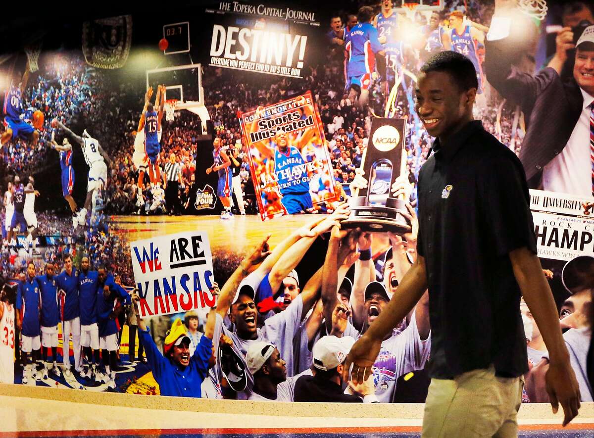 Kansas freshman NCAA college basketball player Andrew Wiggins leaves a news conference at the University of Kansas in Lawrence, Kan., Monday, March 31, 2014. Wiggins announced he would be entering the NBA draft. (AP Photo/Orlin Wagner)