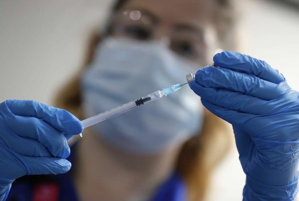 A nurse prepares a shot of the Pfizer-BioNTech COVID-19 vaccine at Guy's Hospital in London, Tuesday, Dec. 8, 2020, as the U.K. health authorities rolled out a national mass vaccination program. Distribution of the Pfizer vaccine to New York is expected as soon as this weekend. (AP Photo/Frank Augstein, Pool)