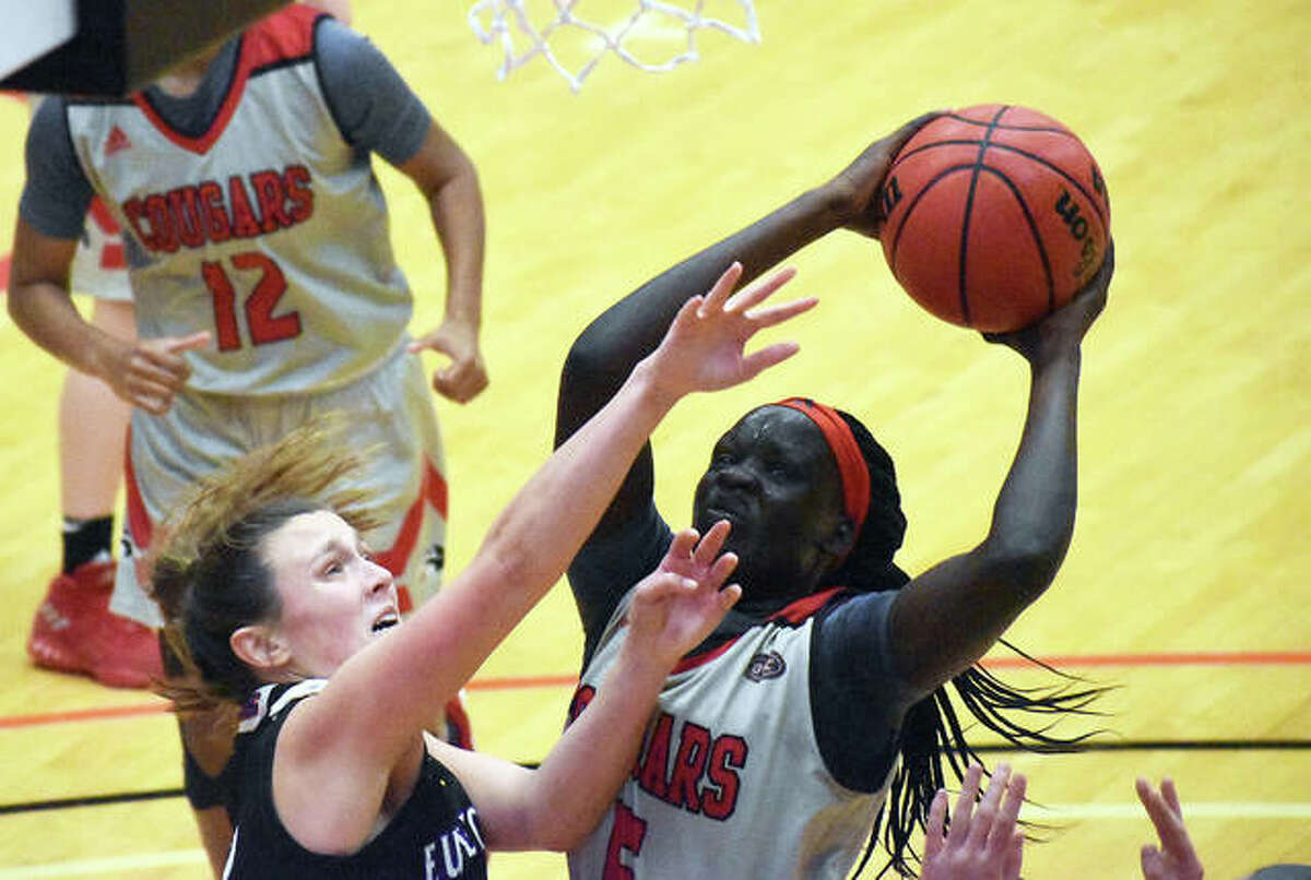 SIUE forward Ajulu Thatha goes up for a contested shot after grabbing an offensive rebound in the first half of Wednesday’s game against the University of Health Sciences and Pharmacy.