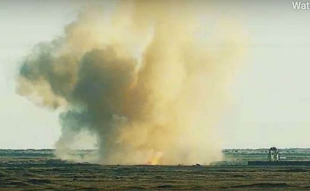 This SpaceX video frame grab image shows SpaceX's Starship SN8 prototype exploding right next to its landing pad at the company's Boca Chica, Texas facility during an attempted high-altitude launch test on December 9, 2020. - SpaceX came within seconds of attempting to launch the latest prototype of its next-generation Starship rocket, until an engine issue stopped the company short of liftoff on December 8, 2020. (Photo by Olivier DOULIERY / SPACEX / AFP) /