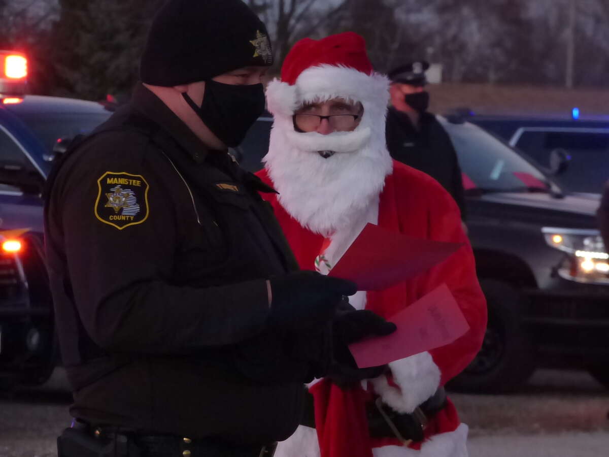 First responders from eight different organizations in Manistee County took part in the annual Shop with a Hometown Hero event on Wednesday, which took on a new look due to the pandemic. Instead of shopping, the "heroes" delivered gifts to families in the parking lot of Manistee Catholic Central.