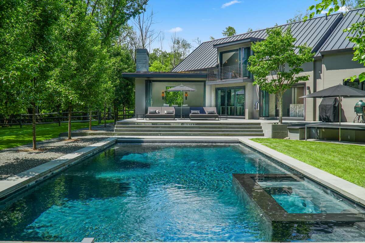 A heated swimming pool and spa at 42 Meeker Hill Road in Redding. Only a mélange of MOMA and an Audubon Society sanctuary would be suitable for this 4,009-square-foot gray house custom-built in 2017, combining uncluttered minimalism with the property’s lush landscape. It was designed for visual enjoyment throughout the four seasons. “This is one of the (most) beautifully designed homes I have ever represented. Upon entering you feel surrounded by a sense of calm and serenity. This Zen-like environment embraces the natural beauty of the outdoors and brings it in,” said Denise Gannalo, the listing agent.  