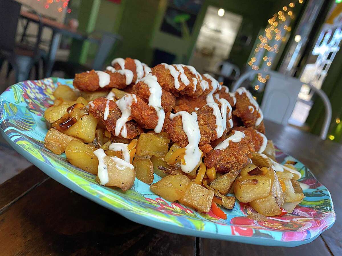Buffalo Hash includes vegan fried chicken nuggets in spicy buffalo sauce, fried potatoes, onions and tangy ranch-style sauce at Hash Vegan Eats on South Flores Street.