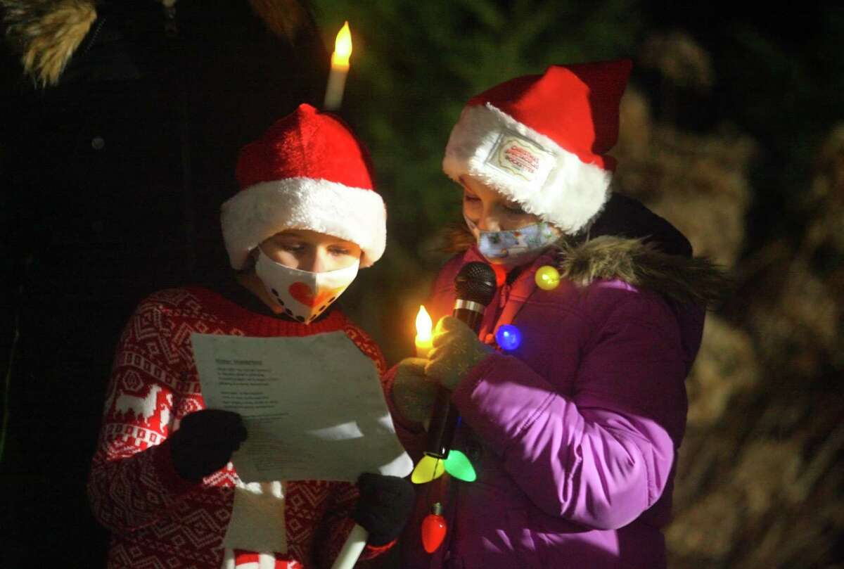 Carolers Megan Panepento and her sister Jenna perform outside for senior residents at Maplewood at Stony Hill, in Bethel, Conn., on Wednesday Dec. 8, 2020. Newtown Youth and Family Services organized the event.