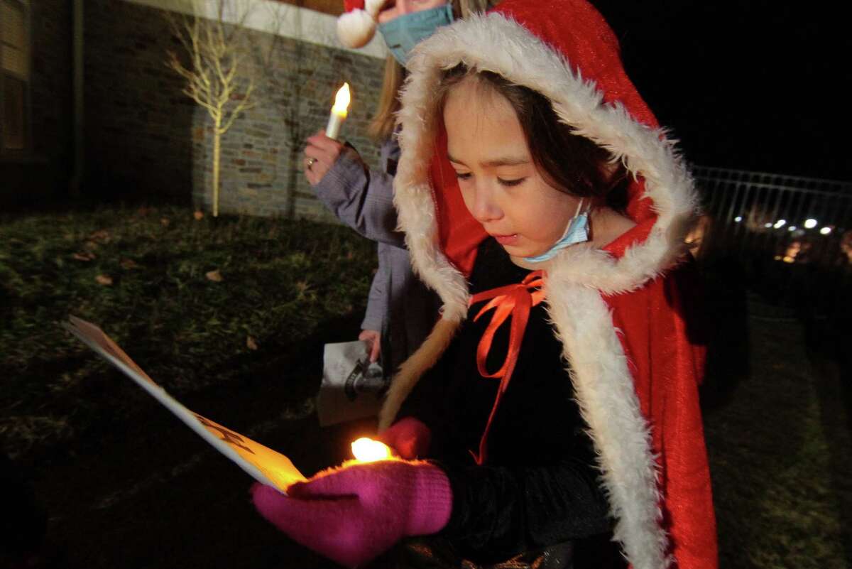 Bailey Moran, 7, joins with other children from Newtown Youth and Family Services to sing Christmas carols for senior residents at Maplewood at Stony Hill, in Bethel, Conn., on Wednesday Dec. 8, 2020.