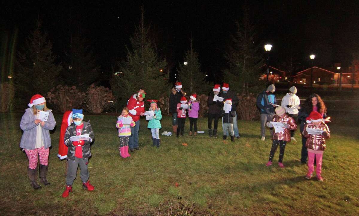 Carolers from Newtown Youth and Family Services perform outside for senior residents at Maplewood at Stony Hill, in Bethel, Conn., on Wednesday Dec. 8, 2020.