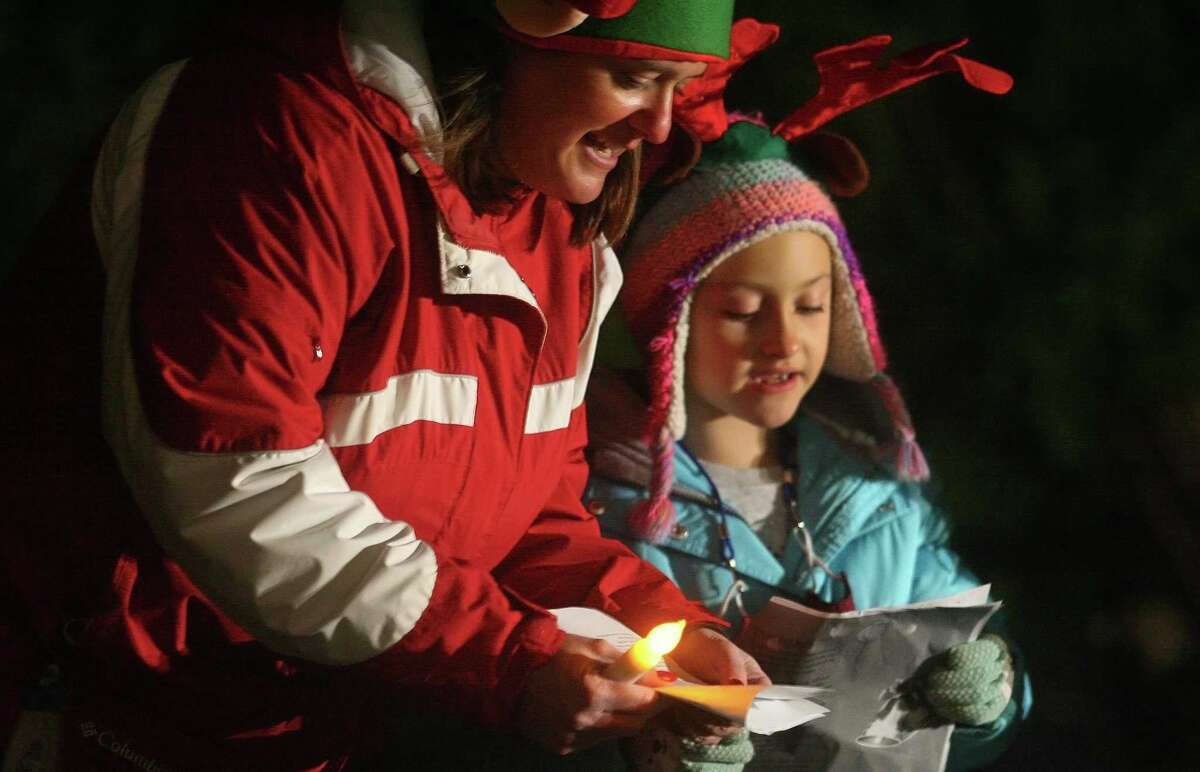 Candace Bohr, with Newtown Youth and Family Services, and her daughter Carrie sing Christmas carols for senior residents at Maplewood at Stony Hill, in Bethel, Conn., on Wednesday Dec. 8, 2020.