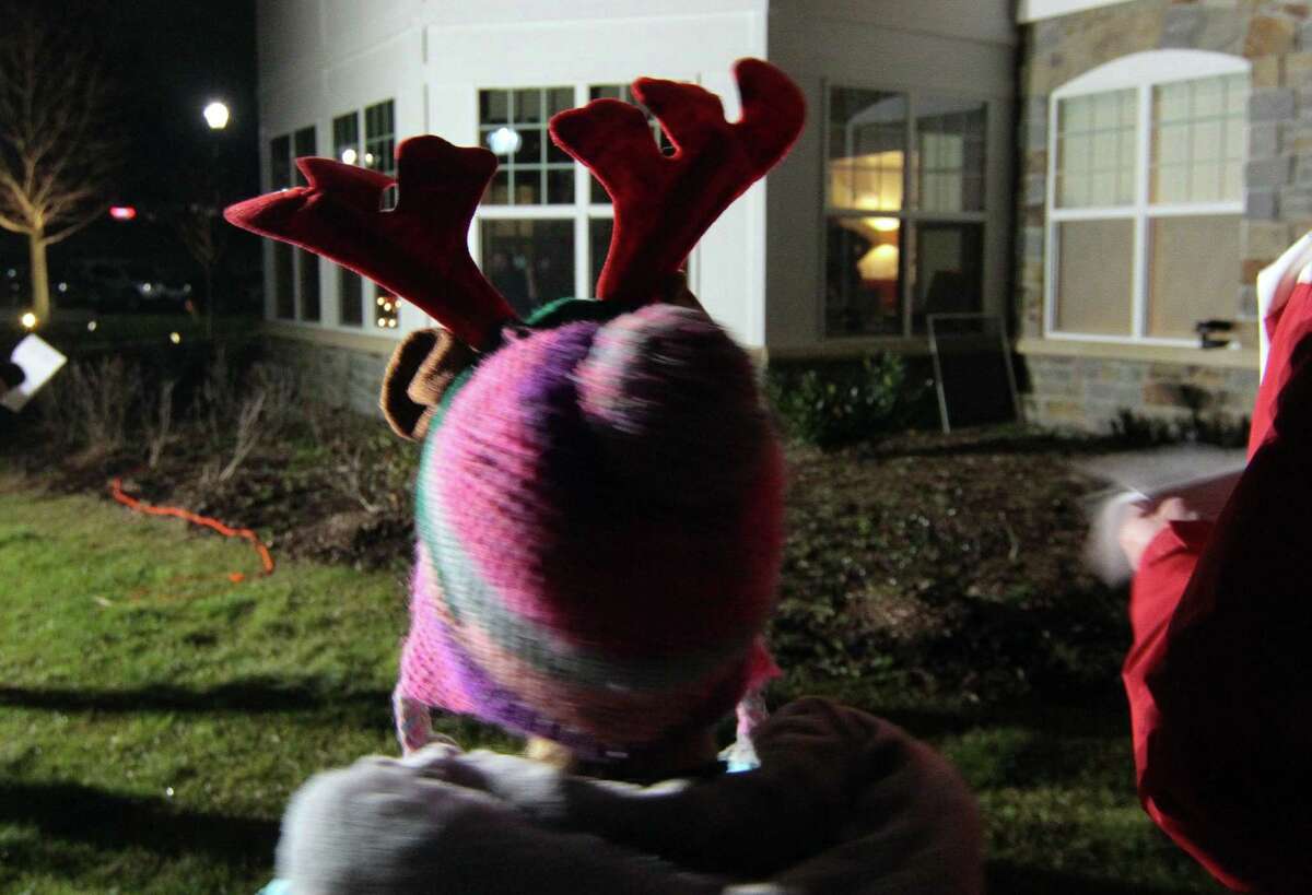 Carolers from Newtown Youth and Family Services perform outside for senior residents at Maplewood at Stony Hill, in Bethel, Conn., on Wednesday Dec. 8, 2020.