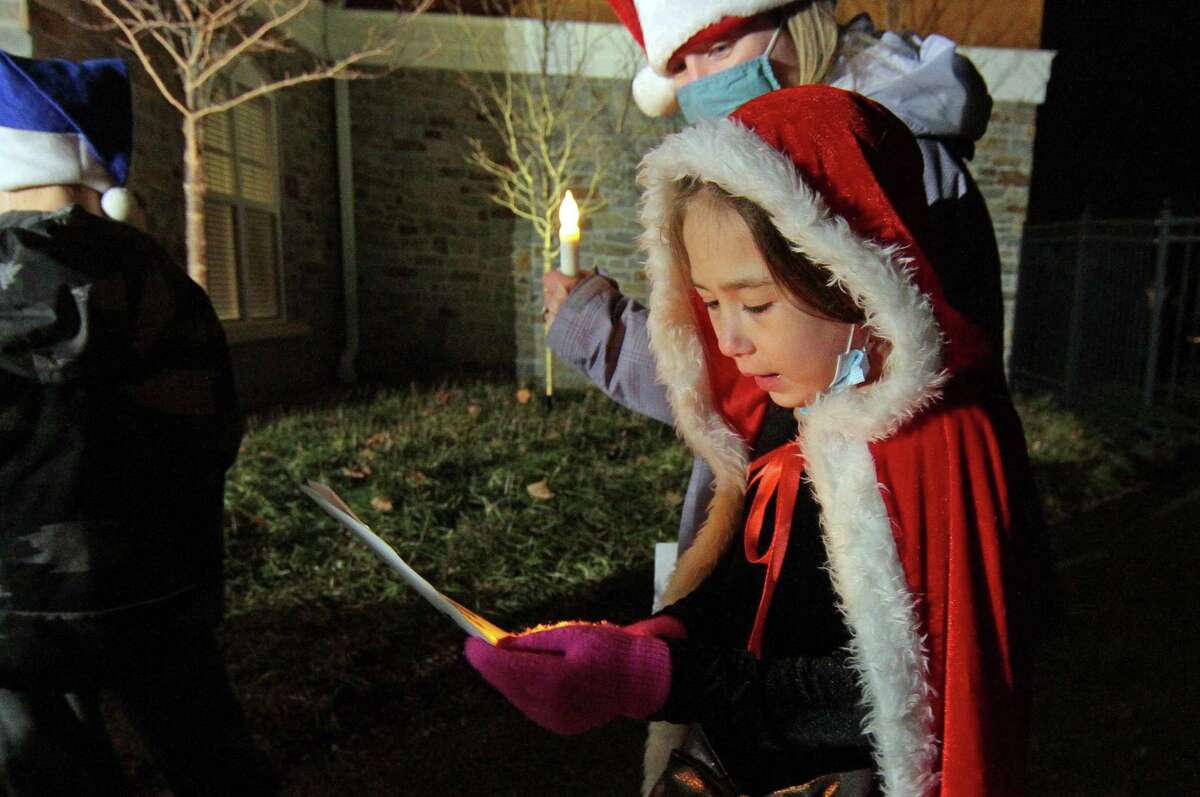 Bailey Moran, 7, joins with other children from Newtown Youth and Family Services to sing Christmas carols for senior residents at Maplewood at Stony Hill, in Bethel, Conn., on Wednesday Dec. 8, 2020.