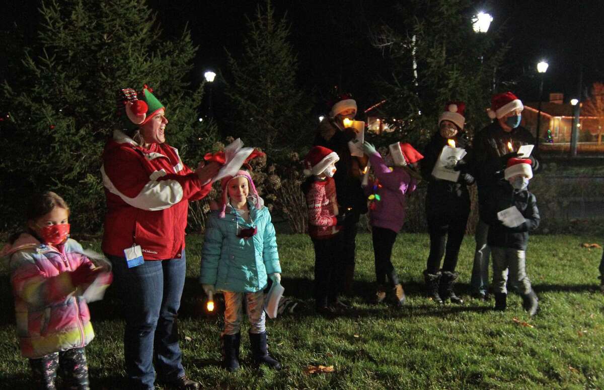 Carolers from Newtown Youth and Family Services perform outside for senior residents at Maplewood at Stony Hill, in Bethel, Conn., on Wednesday Dec. 8, 2020.