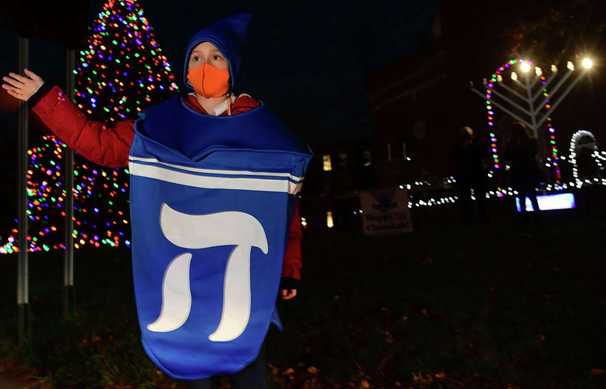 Eli Stone, 9, wore a dreidel costume to a celebration of the start of Hanukkah, the eight-day Jewish Festival of Lights, on the front lawn of City Hall in Norwalk on Thursday, December 10, 2020.