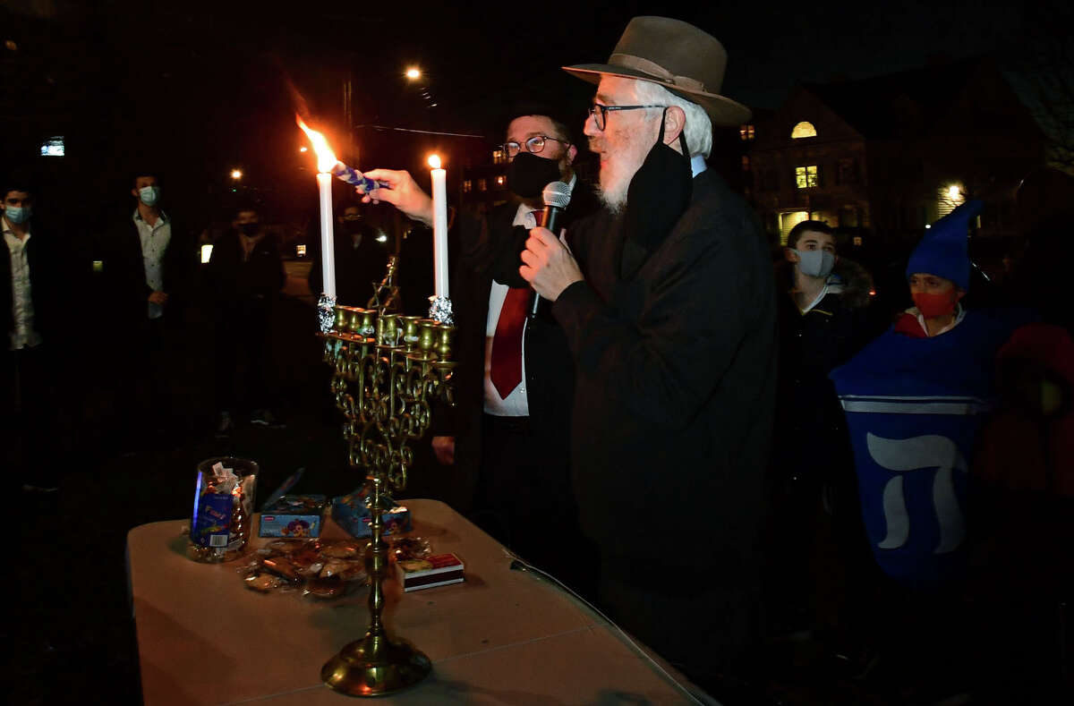Rabbi Yehoshua S. Hecht, Beth Israel, and Rabbi Levi Stone, Schneerson Center for Jewish Life hold a menorah lighting ceremony Thursday, December 10, 2020, marking the first light of the eight-day Chanukah festival on the front lawn of City Hall in Norwalk, Conn. The first day of Hanukkah marks the start of Hanukkah, also known as Chanukah or Festival of Lights. Hanukkah is an eight-day Jewish observance that remembers the Jewish people's struggle for religious freedom.